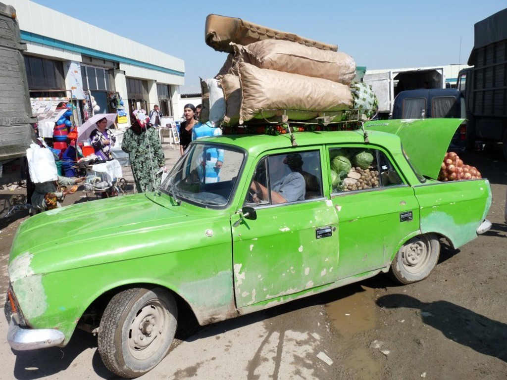 Groene auto vol groente en bagage op een markt langs de Zijderoute tijdens groepsrondreis in het spoor van Marco Polo.